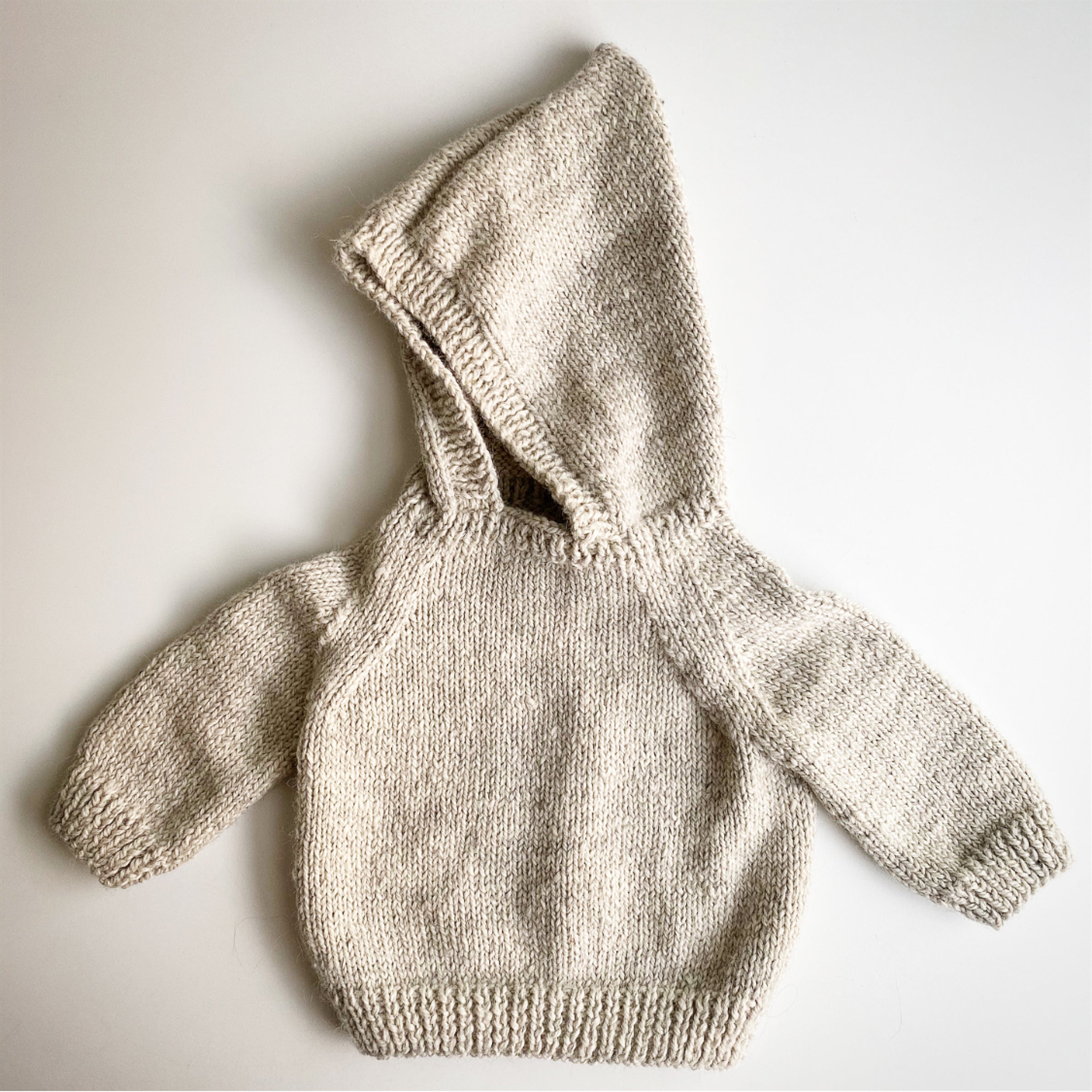 Hooded baby sweater with hotsell back zipper